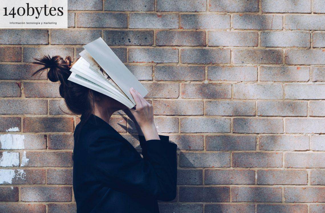 woman covering her face with white book