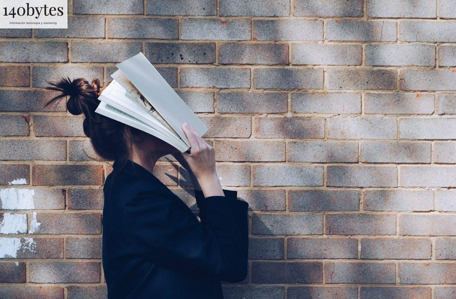 woman covering her face with white book