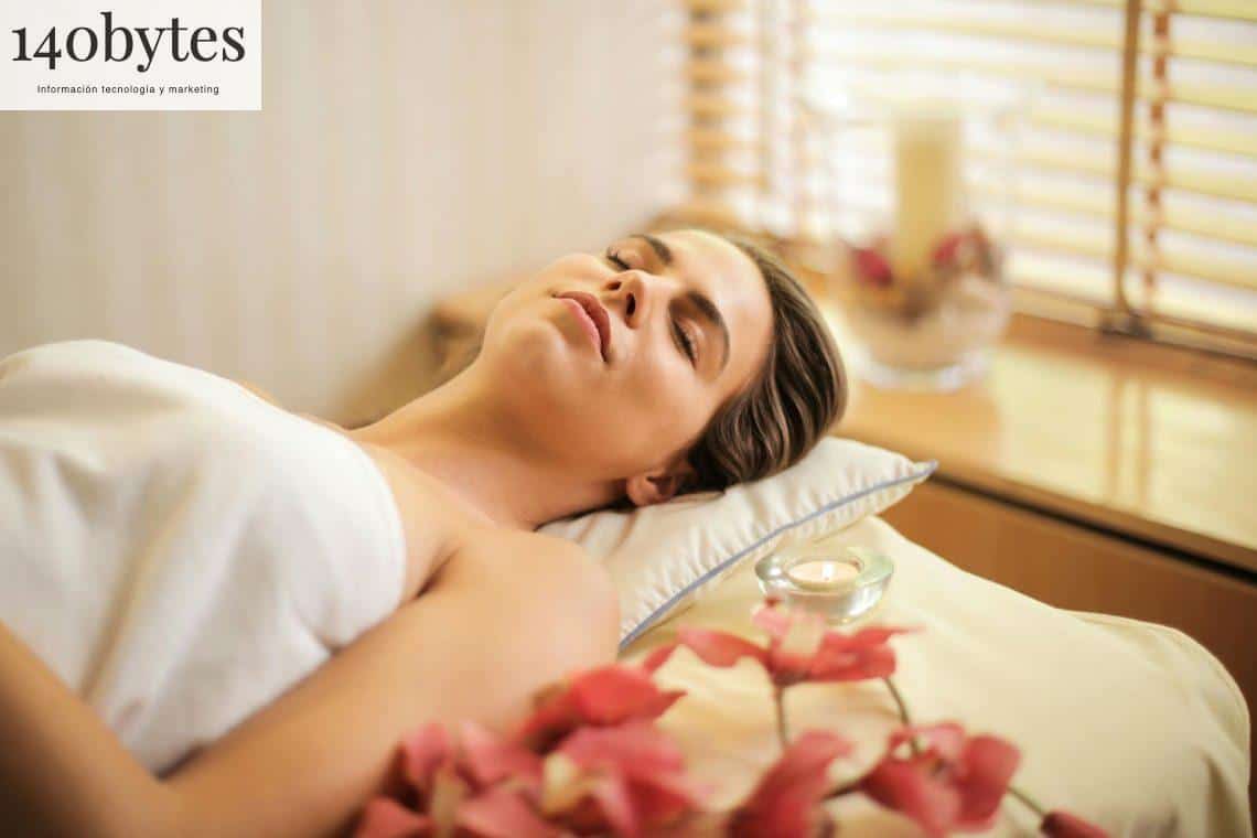 Woman in Wrapped in White Towel Lying on Bed with Eyes Closed