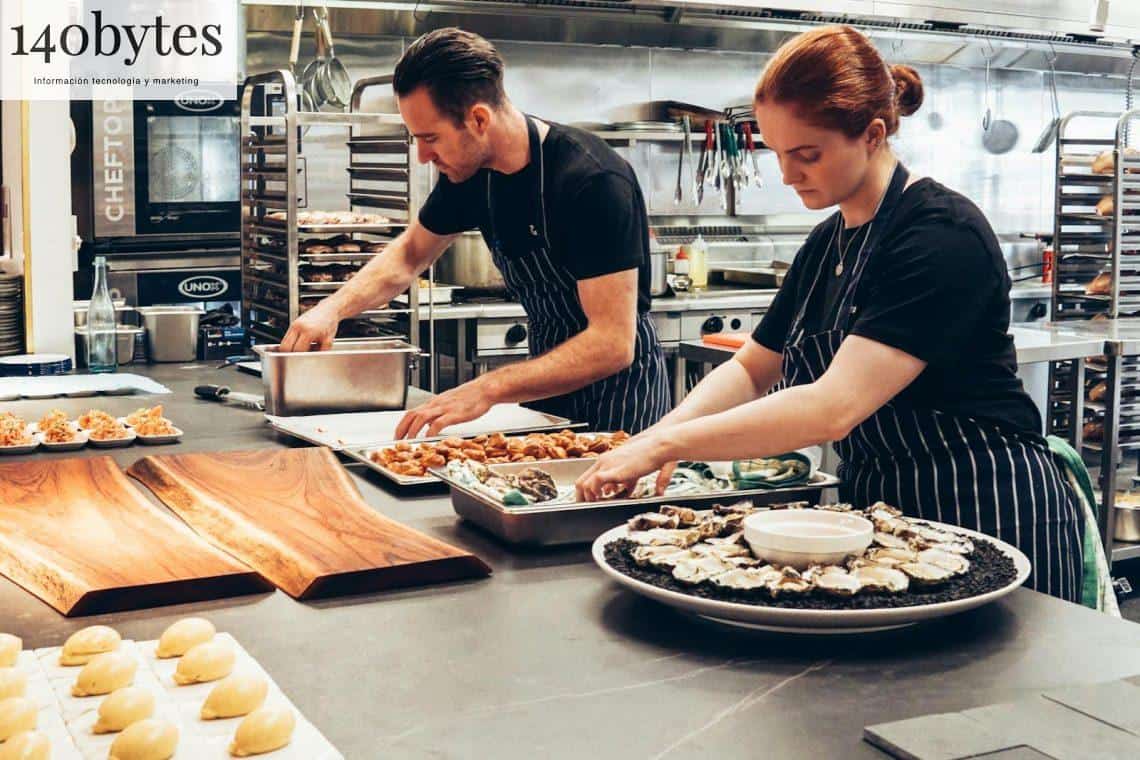 Man and Woman Wearing Black and White Striped Aprons Cooking