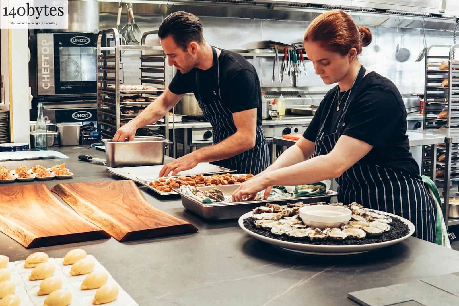 Man and Woman Wearing Black and White Striped Aprons Cooking