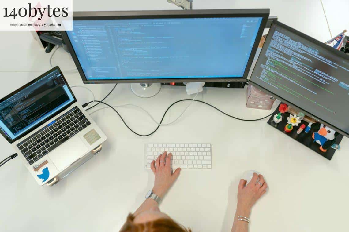 person using macbook pro on white table