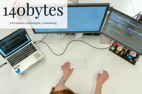 person using macbook pro on white table