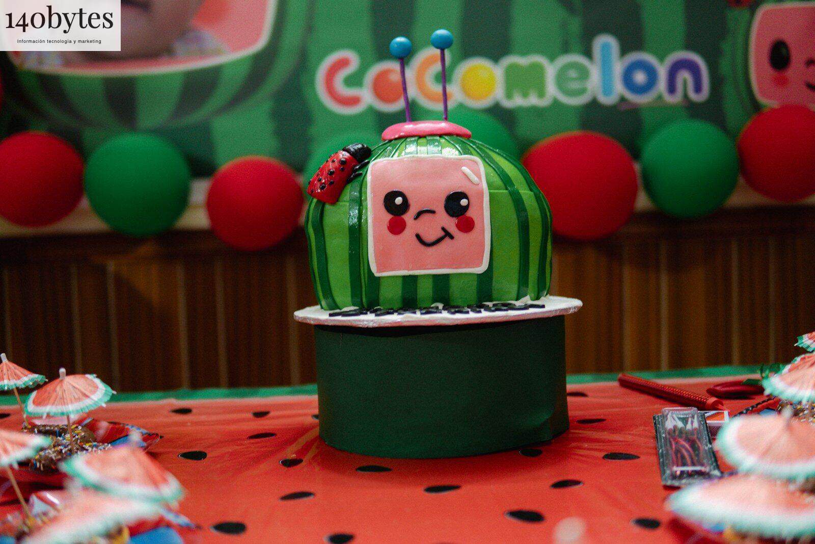 A cocomelon themed cake is displayed